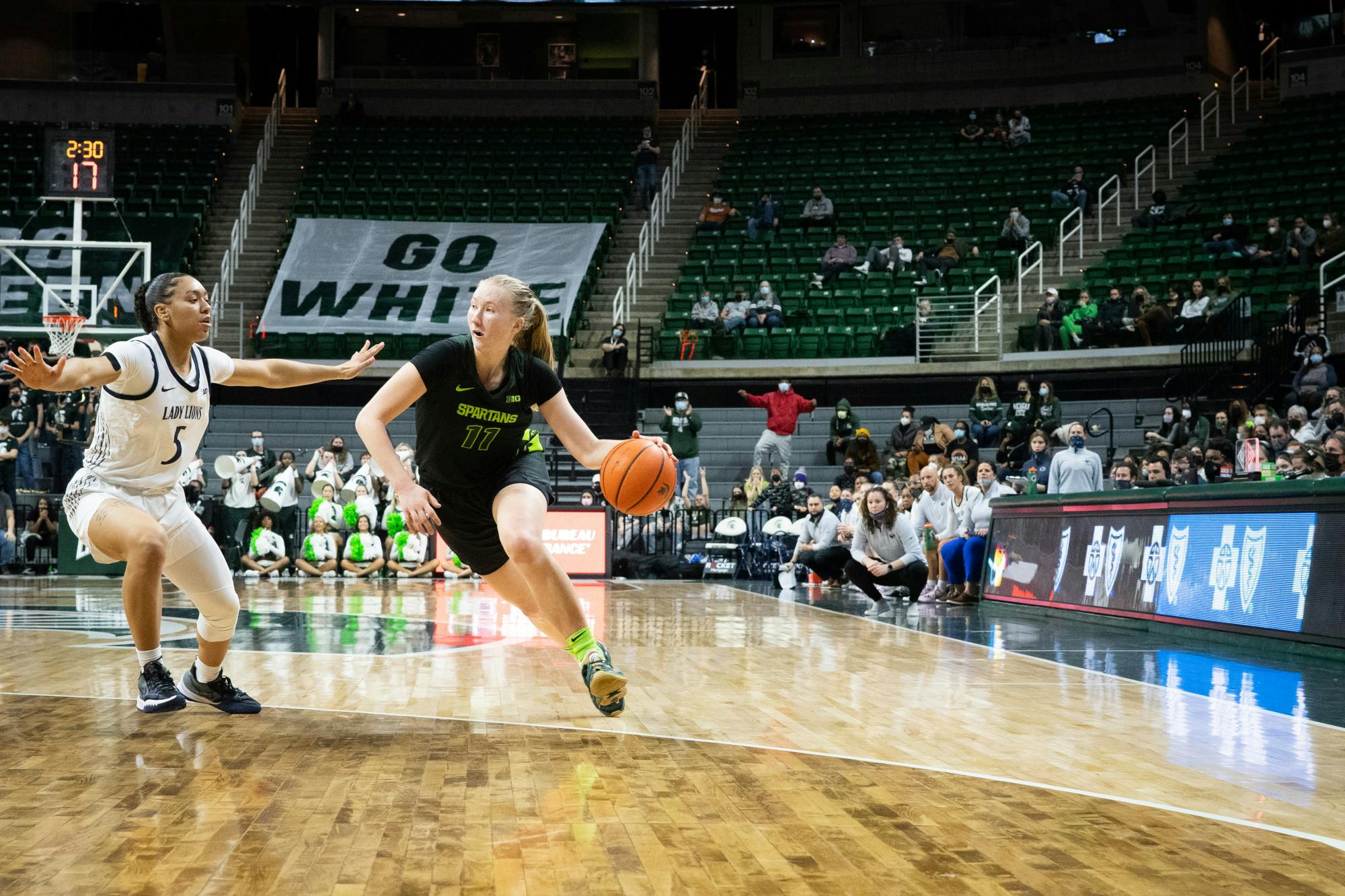 Freshman guard Matilda Ekh (11) tries to get around Penn State’s redshirt freshman guard Leilani Kapinus (5) during an intense game at the Breslin Center on Feb. 21, 2022. The Spartans lost to the Lady Lions 79-71.  