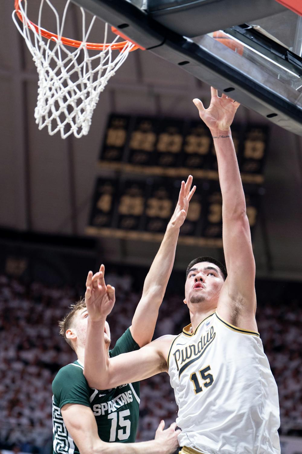 <p>Purdue's junior center Zach Edey (15) goes up for the shot as freshman center Carson Cooper (15) tries to block it during a game against Purdue at Mackey Arena on Jan. 29, 2023. The Spartans lost to the Boilermakers 77-61. </p>