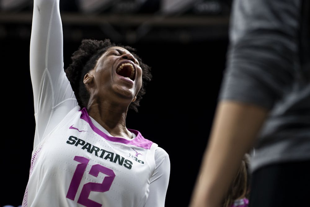 <p>Freshman forward Isaline Alexander (12) yells in excitement during the game against Michigan on Feb. 10, 2022, at the Breslin Center. The Spartans defeated the Wolverines 63-57.</p>