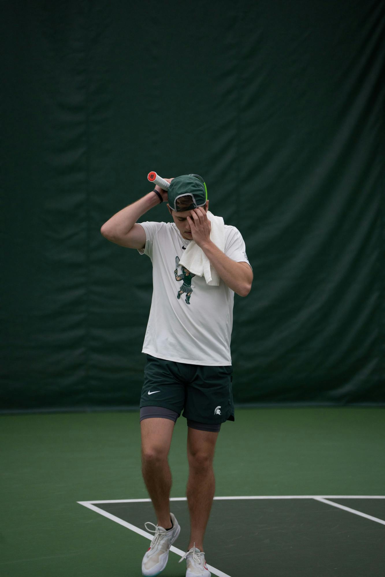<p>Junior Graydon Lair walks away from his singles match against Michigan at the MSU Tennis Center on March 30, 2023. The Spartans lost to the Wolverines 6-1.</p>