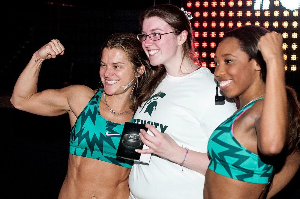 	<p>Marketing senior Shannon McGreal-Miller, center, poses for a photograph with Nike trainers Holly Rilinger, left, and Deanna Jefferson after the Nike pregame workout March 29, 2013, at Breslin Center. Students received Nike gear after the workout. Katie Stiefel/The State News</p>