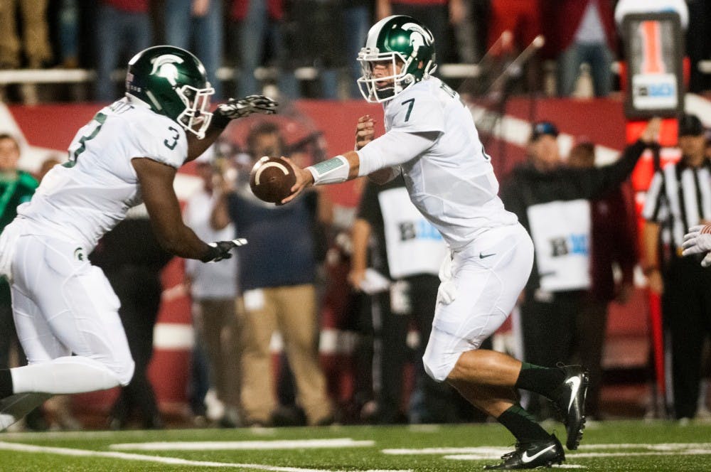 Senior quarterback Tyler O'Connor (7) hands off the football to sophomore running back LJ Scott (3) during the game against Indiana on Oct. 1, 2016 at Memorial Stadium in Bloomington, Ind.