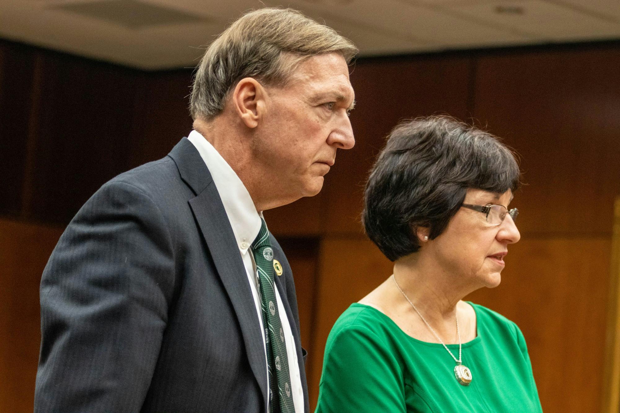 <p>MSU President Samuel L. Stanley Jr., left, and Trustee Dianne Byrum, right, listen at a press conference at the Board of Trustees meeting on Dec. 13. 2022. </p>