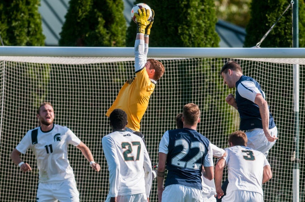 <p>Then-sophomore goalkeeper Zach Bennett jumps up for a save during the game against Penn State on Oct. 20, 2013, at DeMartin Soccer Stadium. The Spartans fell to the Nittany Lions in double overtime, 1-2. Khoa Nguyen/The State News.</p>
