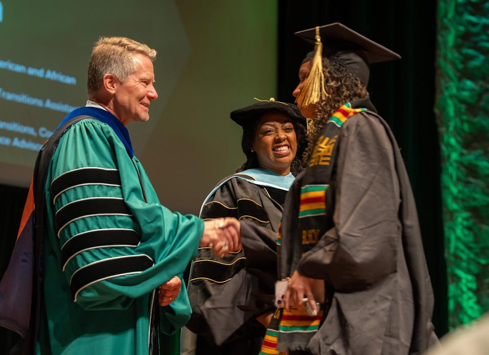 Michigan State University President Kevin Guskiewicz congratulates students during the annual Black Graduation ceremony at the Wharton Center on April 21, 2024.