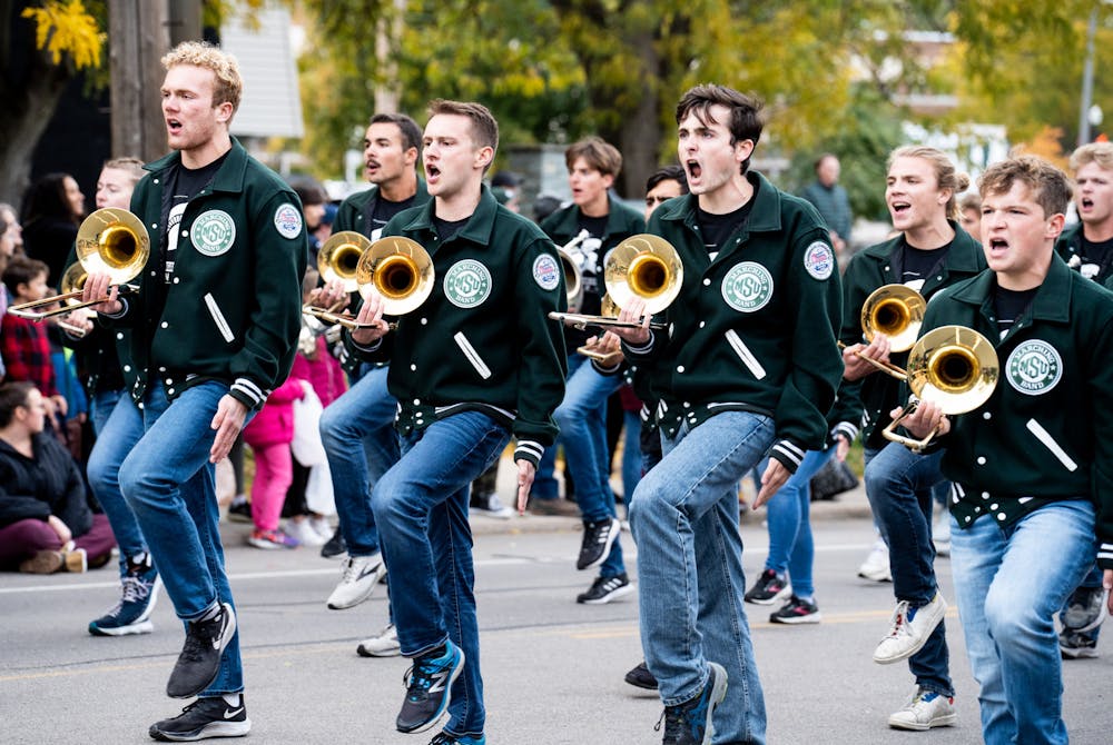 The MSU Marching Band march with their instruments at the MSU Homecoming Parade on Oct. 14, 2022. 