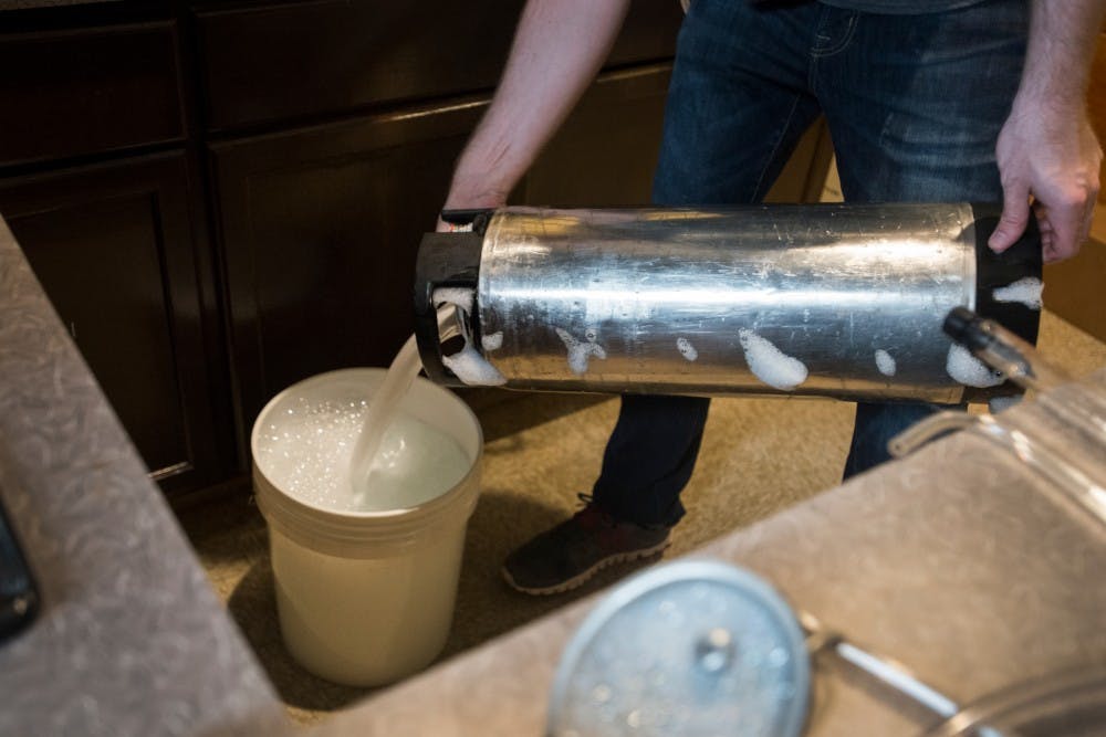 Holt, Mich. resident Jacob Schopp uses sanitizer to clean the inside of a keg on June 6, 2016 at Capital City Homebrew Supply at 623 E. Michigan Ave. in Lansing, Mich. The sanitizer eliminates any wild yeast or bacteria.