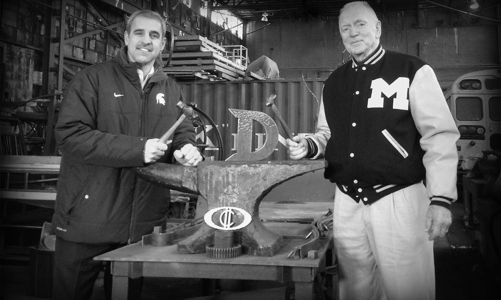 MSU hockey head coach Tom Anastos, left, and Michigan hockey head coach Red Berenson pose for a portrait at the Detroit Design Center Studio. Photo Courtesy Erik Nordin 