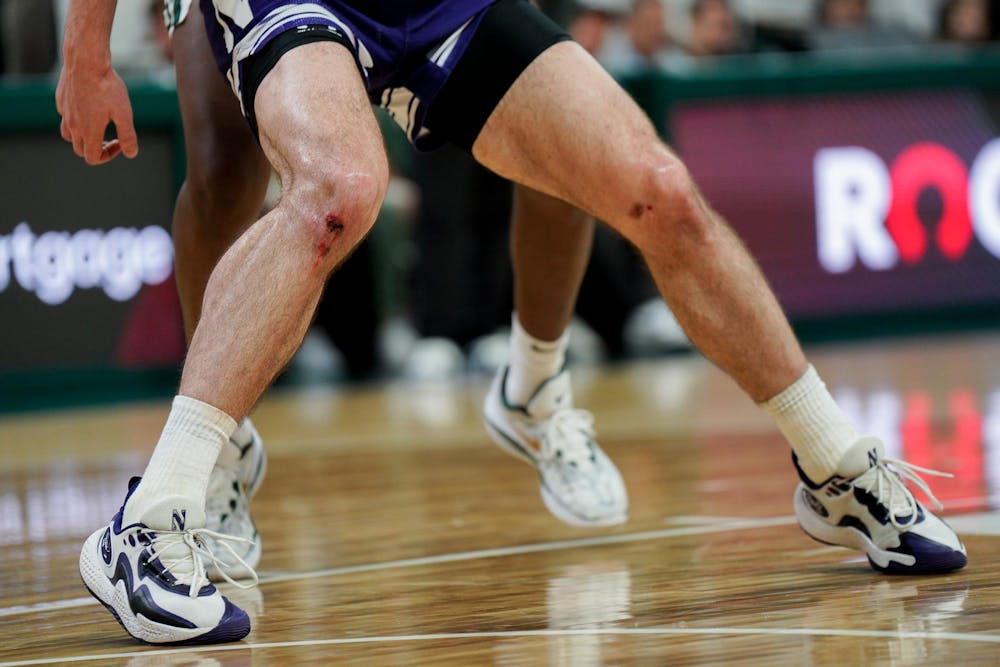 The scabbed knees of University of Northwestern’s Brooks Barnhizer (13) during a match at the Breslin Center on March 6, 2024. The Spartans defeated the Wildcats with a score of 53-49. 
