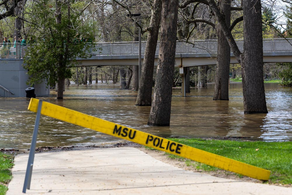 The Red Cedar River flood between the Main Library and Spartan Stadium in East Lansing, Michigan on Friday, April 17, 2026. 