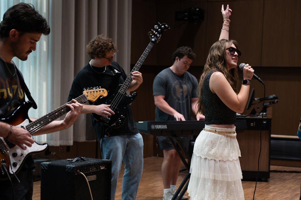 <p>Luke Karsten, Alina Morse, Kade Ringer and Kyle Quick (from left) practice for their band, Roxy Riot, at the MSU Music Building in East Lansing, Mich., on July 17, 2026.</p>