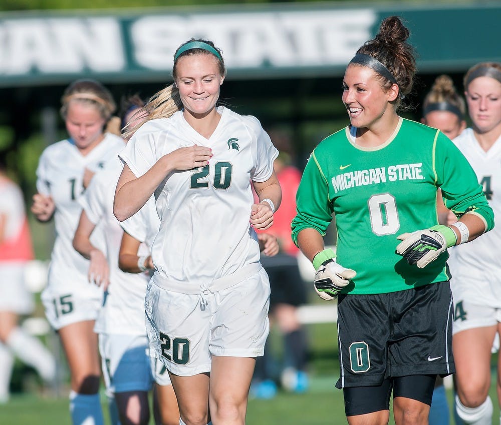 	<p>From left, senior forward Olivia Stander laughs with sophomore goaltender Courtney Clem Wednesday, Sept. 12 at DeMartin Stadium at Old College Field. The Spartans won 1-0 in the final game before conference play. Adam Toolin/The State News</p>