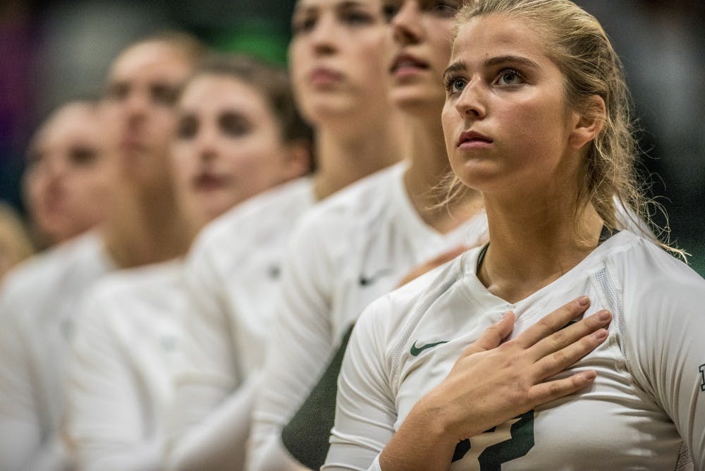 Sophomore defensive specialist Samantha McLean (22) looks at the flag during the National Anthem during the game against Ohio State on Sept. 30, 2017 at Jenison Fieldhouse. The Spartans defeated the Buckeyes, 2-0. 