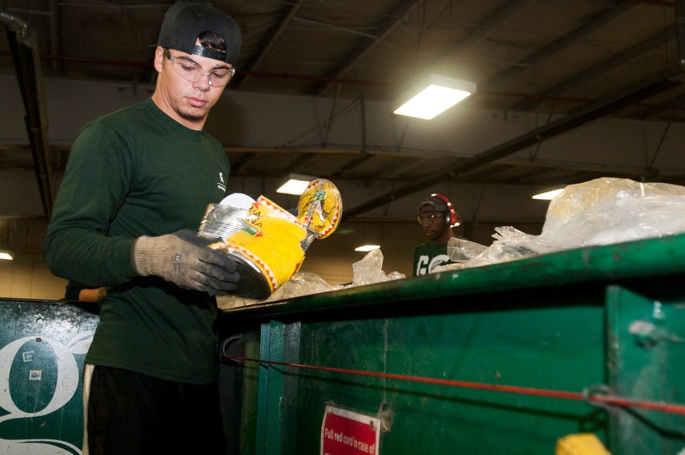 <p>LCC criminal justice junior Kaleb Dunn sorts through trash on the conveyer belt on Oct. 22, 2015 at the MSU Surplus Store and Recycling Center in East Lansing. </p>