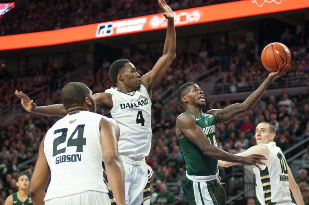 Junior guard Eron Harris goes for a layup as Oakland forward Jalen Hayes attempts to block him on Dec. 22, 2015 during the game against Oakland University at the Palace of Auburn Hills in Auburn Hills, Mich. The Spartans defeated the Grizzlies, 99-93 in overtime.