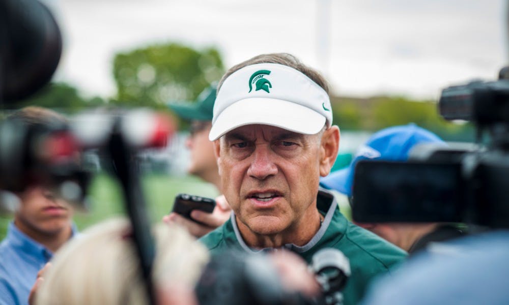 <p>Head coach Mark Dantonio is pictured on Aug. 24, 2017 at the practice fields behind Duffy Daugherty Football Building. Dantonio announced seniors offensive lineman Brian Allen and Chris Frey as the two captains of the MSU football team.</p>