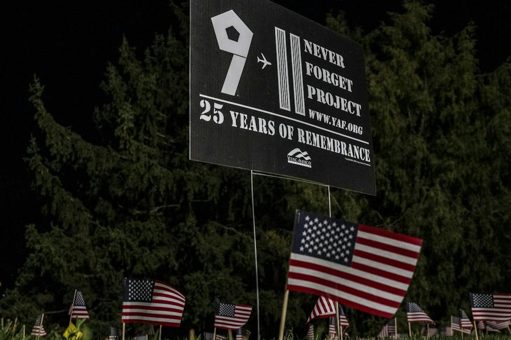 American flags surround a sign for Young America’s Foundation’s Never Forget Project during a 9/11 memorial at the Rock on Michigan State University’s campus in East Lansing, Mich., Thursday, Sept. 10, 2026. MSU Young Americans for Freedom and MSU College Republicans placed 2,977 flags around the Rock, one for each victim killed in the Sept. 11, 2001, terrorist attacks.
