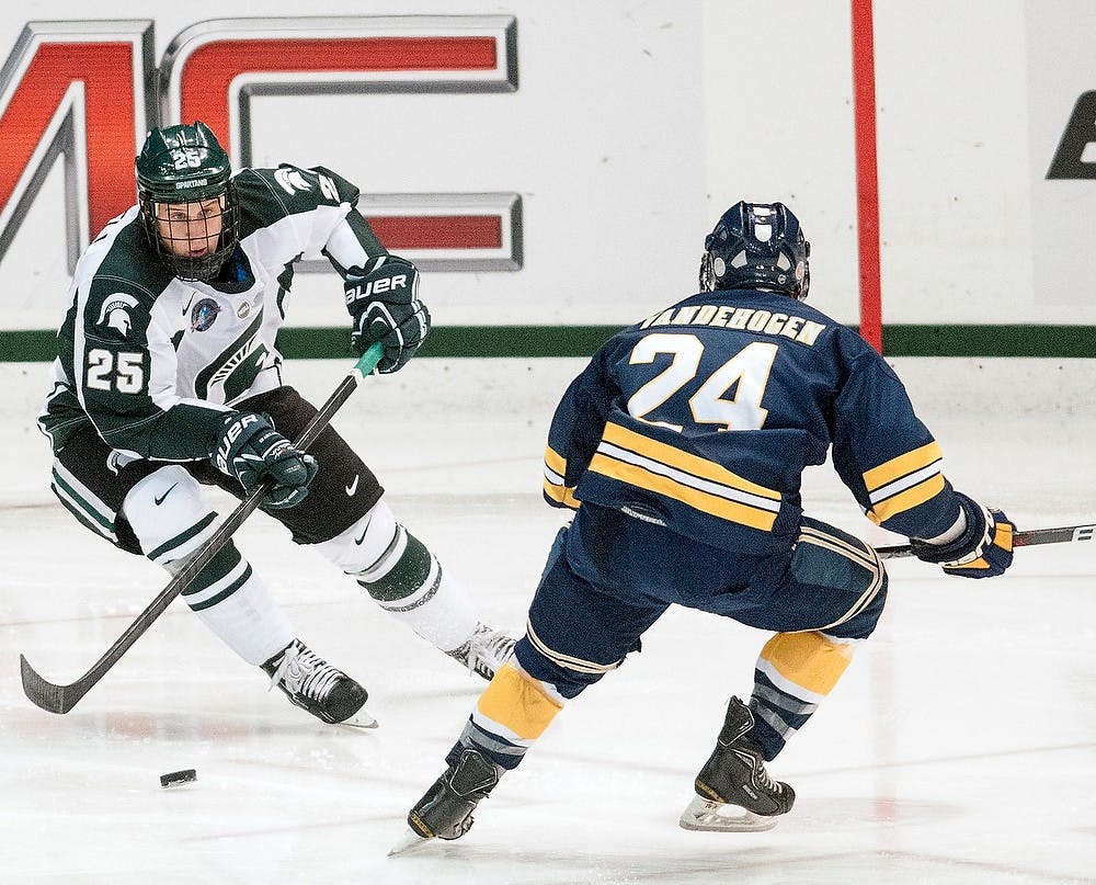 	<p>Sophomore forward Brent Darnell skates the puck up the ice past Windsor forward Brett Vandehogen on Monday night, Oct. 8, 2012, at Munn Ice Arena. <span class="caps">MSU</span> defeated Windsor, 6-1in the first and only exhibition game. Adam Toolin/The State News</p>