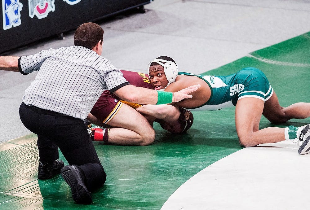 	<p>Sophomore 157-pounder Ryan Watts looks up to the referee as he wrestles Central Michigan&#8217;s Luke Smith on Feb. 22, 2013, at Jenison Field House. Watts defeated Smith 7-3. Adam Toolin/The State News</p>