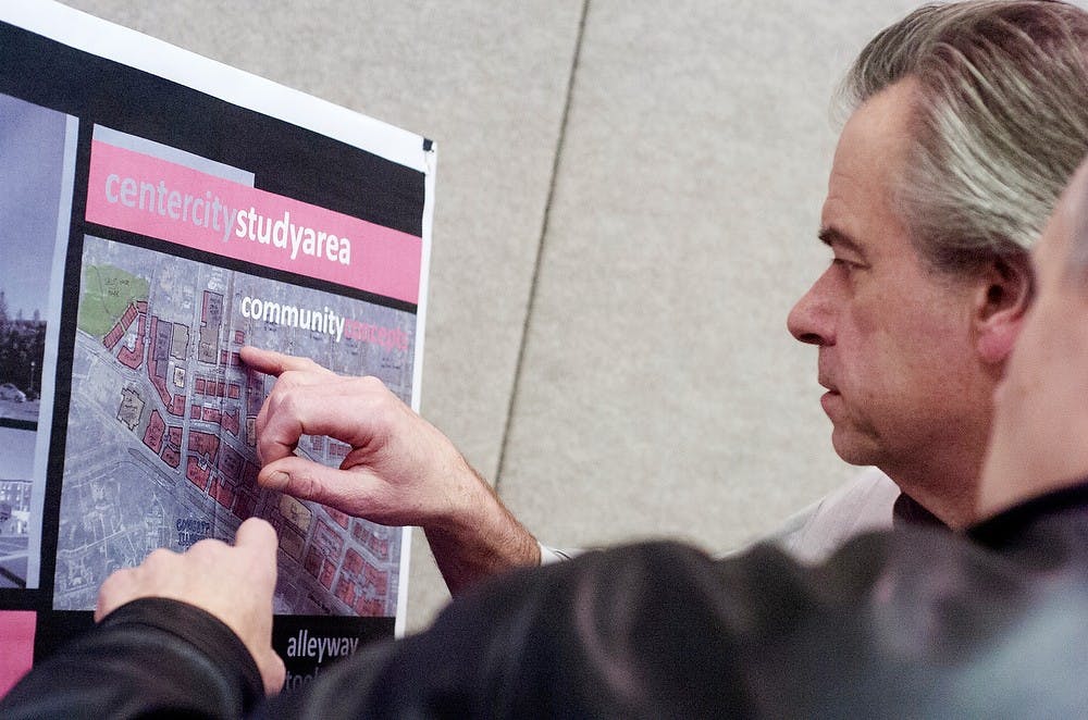 	<p>Professor of construction management and Urban Form Steering Committee member Tim Mrozowski looks over a poster board created by the planning commission on Nov. 4, 2013, in the Ballroom of the Marriott on M.A.C Avenue. The meeting took place as part of East Lansing&#8217;s comprehensive plan review. Olivia Dimmer/ The State News</p>