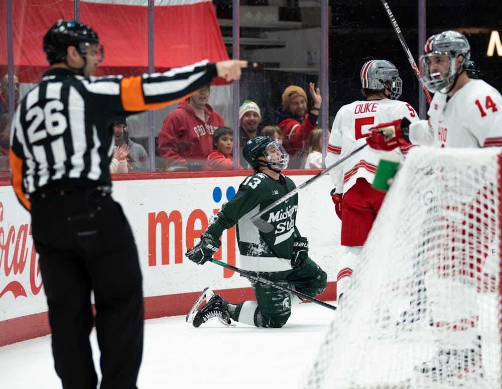 Freshman forward Tiernan Shoudy (13) gets up after Ohio State’s freshman defenseman Tyler Duke (5) gets put in the penalty box during game at Schottenstein Center on Jan. 7, 2023. The Spartans lost to the Buckeyes with a score of 6-0.