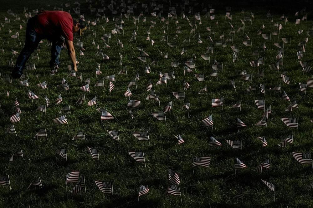 <p><strong>Kort Ian, a junior studying agribusiness and a Marine Corps veteran who served seven years, places an American flag at the Rock during a 9/11 memorial hosted by MSU Young Americans for Freedom and MSU College Republicans on Michigan State University’s campus in East Lansing, Mich., Thursday, Sept. 10, 2026. The organizations placed 2,977 flags, one for each victim killed in the Sept. 11, 2001, terrorist attacks.</strong></p>
