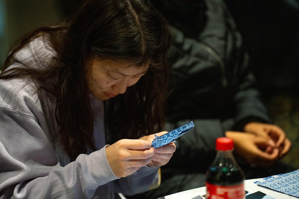 <p>an attende folding at the UAB Jaws Origami event at the MSU Union in East Lansing, on Jan. 31st, 2026</p>