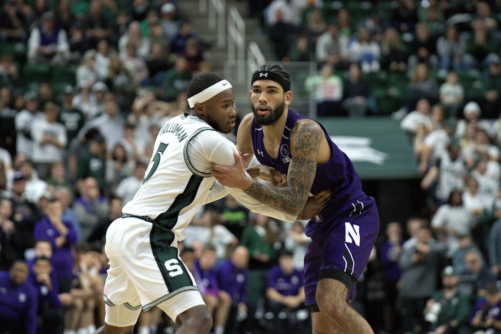 <p>Spartan guard Tre Holloman guards against his Wildcat opponent during the match on Dec. 4, 2022.﻿</p>