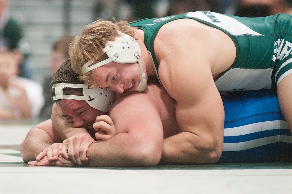 	<p>Junior Mike McClure and Lindsey Wilson&#8217;s Jonathan Hupp wrestle during a meet Jan. 6, 2013, at Jenison Field House. McClure won after a fall 3:09 into the match. Julia Nagy/The State News</p>