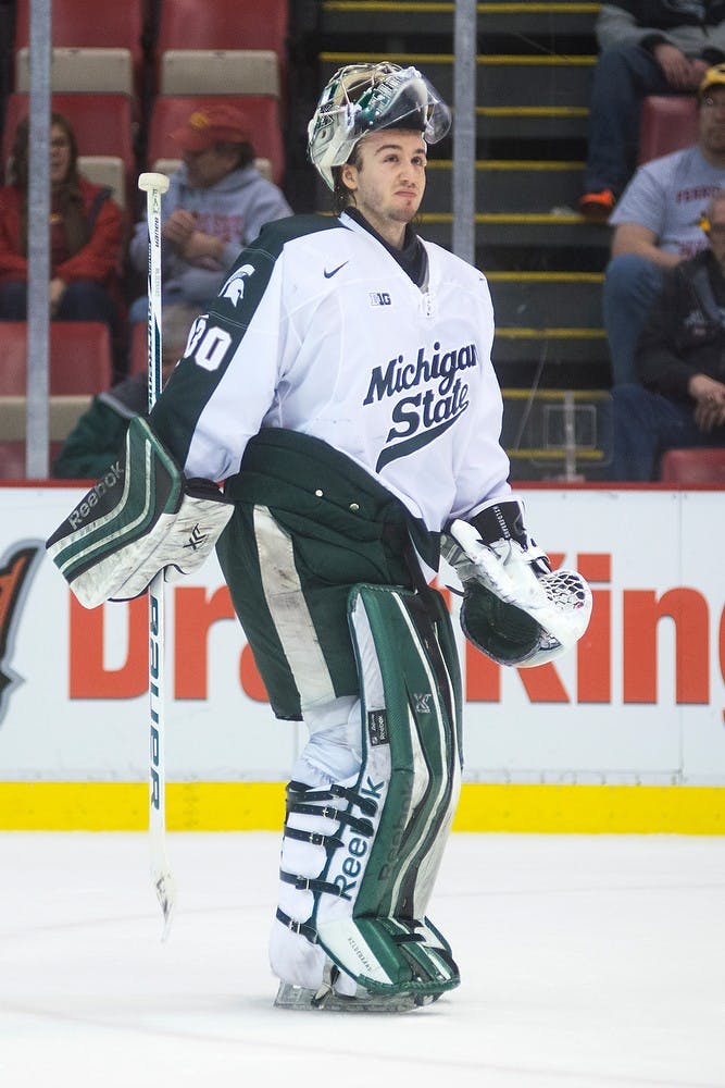 <p>Junior goaltender Jake Hildebrand reacts to a Spartan goal on an empty Ferris State net Dec. 28, 2014, during the 50th Great Lakes Invitational at Joe Louis Arena in Detroit. The Spartans defeated the Bulldogs, 2-0. Danyelle Morrow/The State News</p>