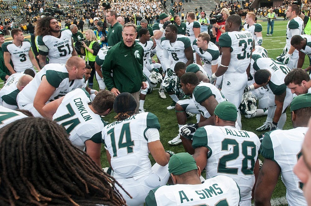 <p>Head coach Mark Dantonio gets fired up after a postgame prayer with his team, Oct. 5, 2013, at Kinnick Stadium. The Spartans defeated the Hawkeyes, 26-14. Khoa Nguyen/The State News</p>