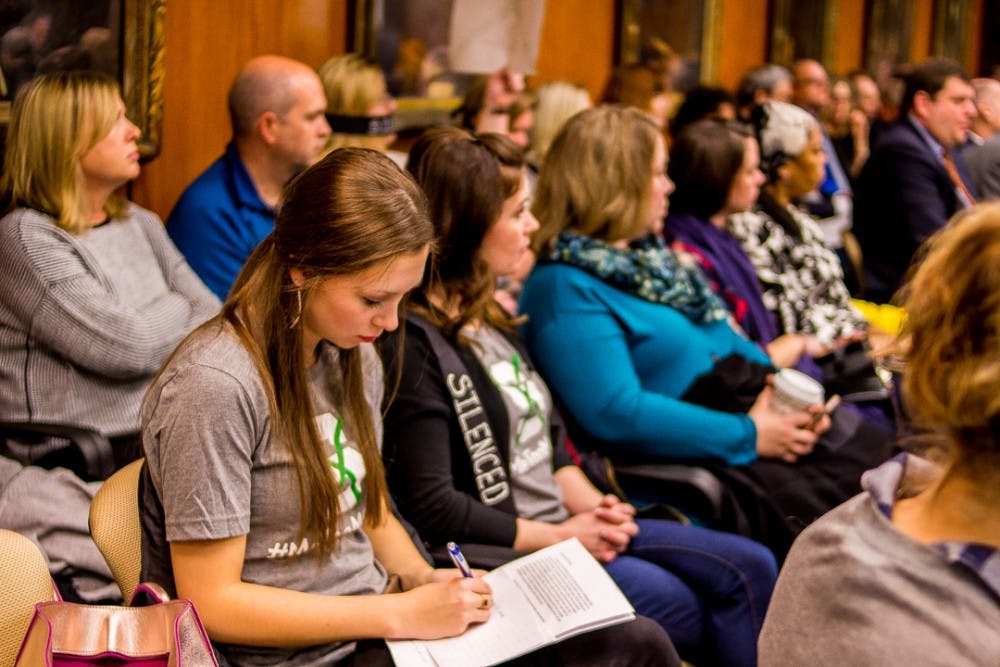 <p>Jessica Smith, one of Nassar’s victims writes notes before addressing the board on Dec 15, 2017 at the Hannah Administration Building. Protesters gathered to address the misconduct of MSU’s handling of the Larry Nassar investigation.&nbsp;</p>