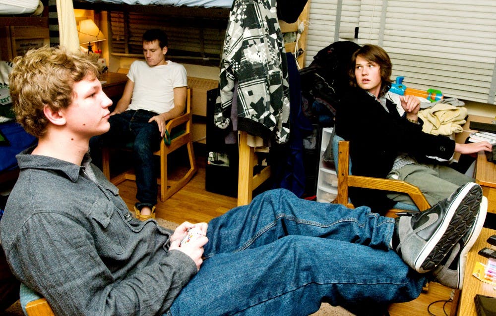 From Left, math and computer science freshman J.J. Peter, clinical lab science freshman Steve Dolinski, and art history visual culture freshman Andrew Scales hangout in their transitional housing dorm room Wednesday night in Armstrong Hall. Peter, Dolinski, and Scales are 3 of the many others booked in transitional housing. Aaron Snyder/The State News. 