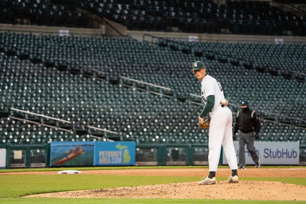 <p>MSU redshirt junior pitcher Wyatt Rush (6) looks back at first base before pitching. The Spartans&#x27; faced the Notre Dame Fighting Irish at Comerica Park on April 26, 2022.</p>