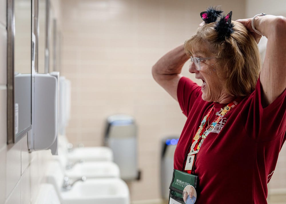 An Odyssey of the Minds judge and volunteer fixes her headband at Wells Hall in East Lansing, Michigan on May 22, 2025. 