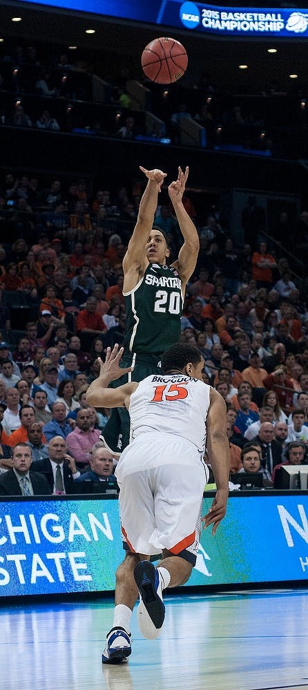 <p>Senior guard Travis Trice shoots March 22, 2015, during the game against Virginia in the Round of 32 of the NCAA tournament at the Time Warner Cable Arena in Charlotte, NC. The Spartans defeated the Cavaliers 60-54.  Alice Kole/The State News</p>