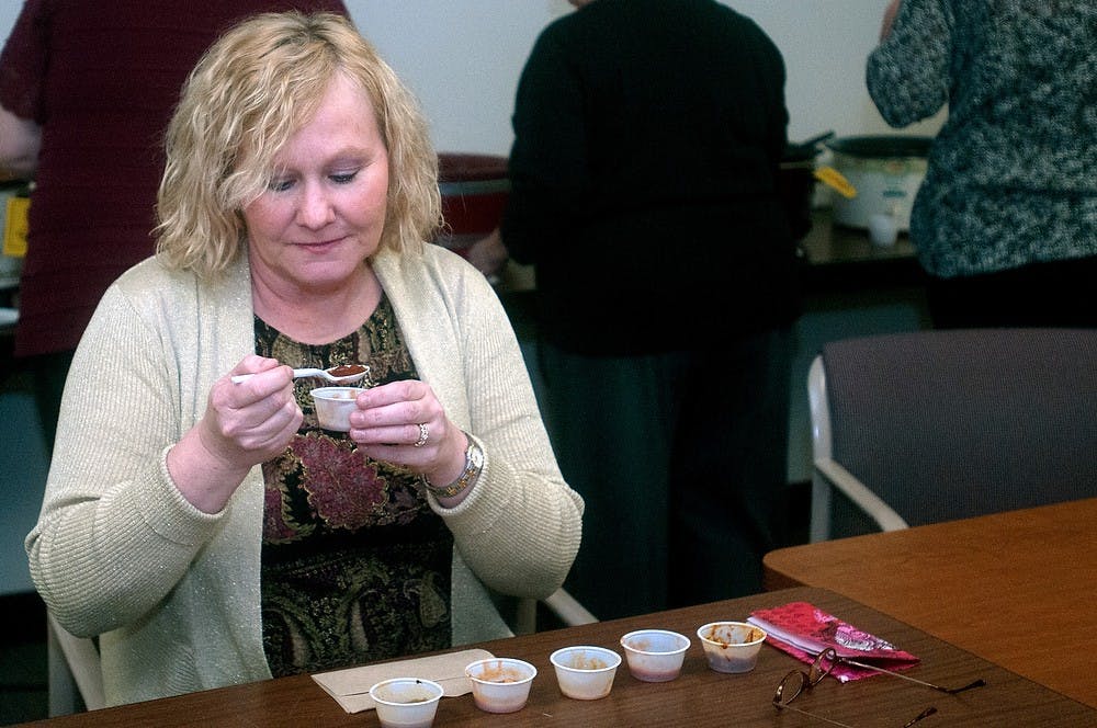 	<p>Lansing resident Terri Badgley tastes different kinds of chili on Wednesday at Agriculture Hall. The <span class="caps">MSU</span> Extension Climate Change Team was hosting its first chili cook-off. Betsy Agosta/The State News</p>