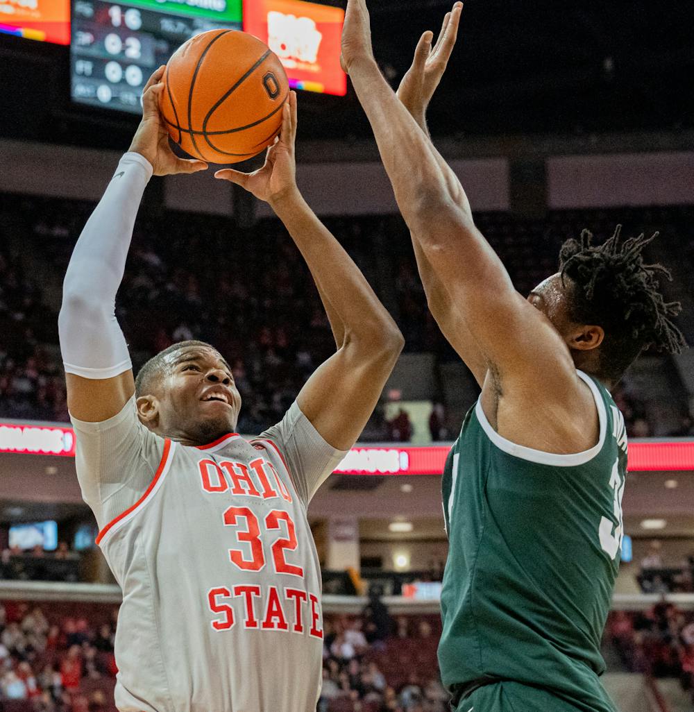 <p>Ohio State junior forward E.J. Liddell goes up for a bucket against Michigan State junior forward Julius Marble during Michigan State&#x27;s visit to Value Center Arena against Ohio State on Mar. 3, 2022.</p>