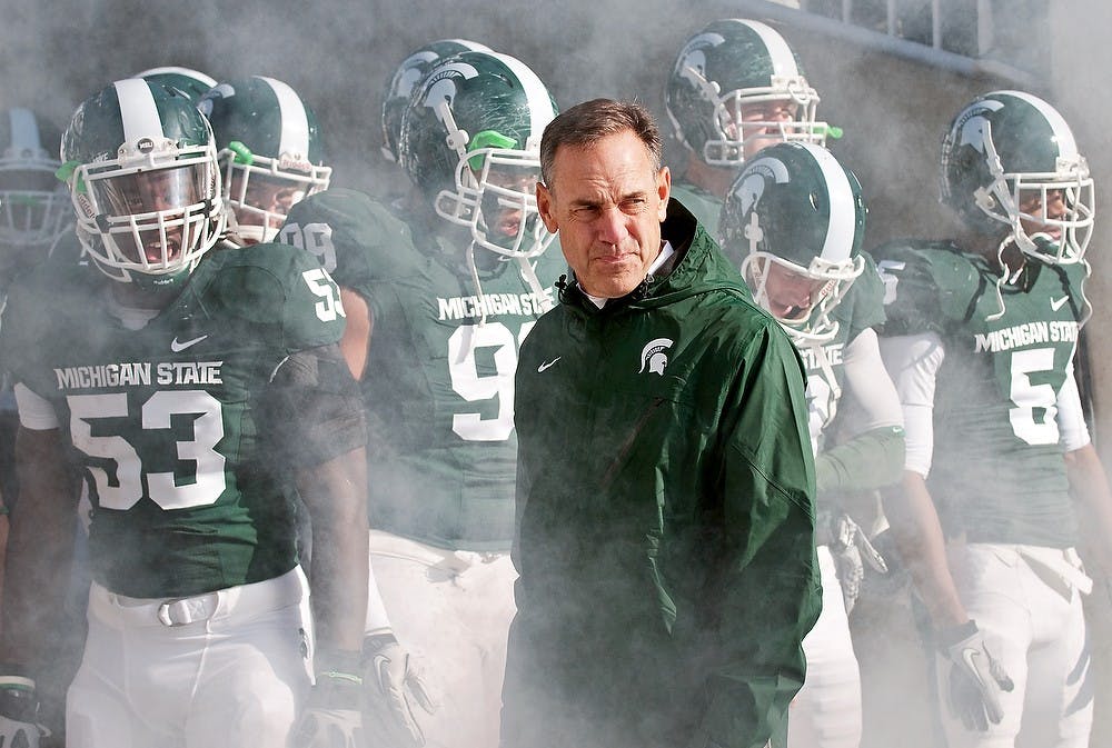 <p>Head coach Mark Dantonio stands with his Spartans before they take the field against Minnesota on Nov. 6, 2010, at Spartan Stadium. Josh Radtke/The State News</p>