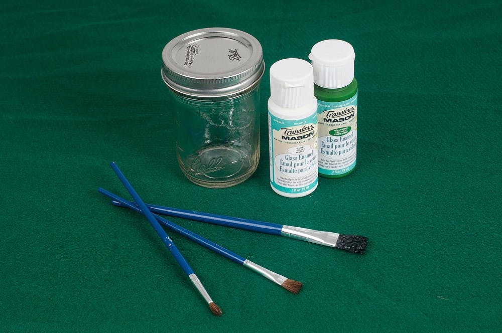 	<p>Items: Mason jar ($7.97 for 12 pack of half pint jars at Meijer, 2055 W. Grand River Ave., in Okemos), green and white glass enamel paint (Mason brand, $1.74 per bottle at Meijer) and paint brushes.</p>