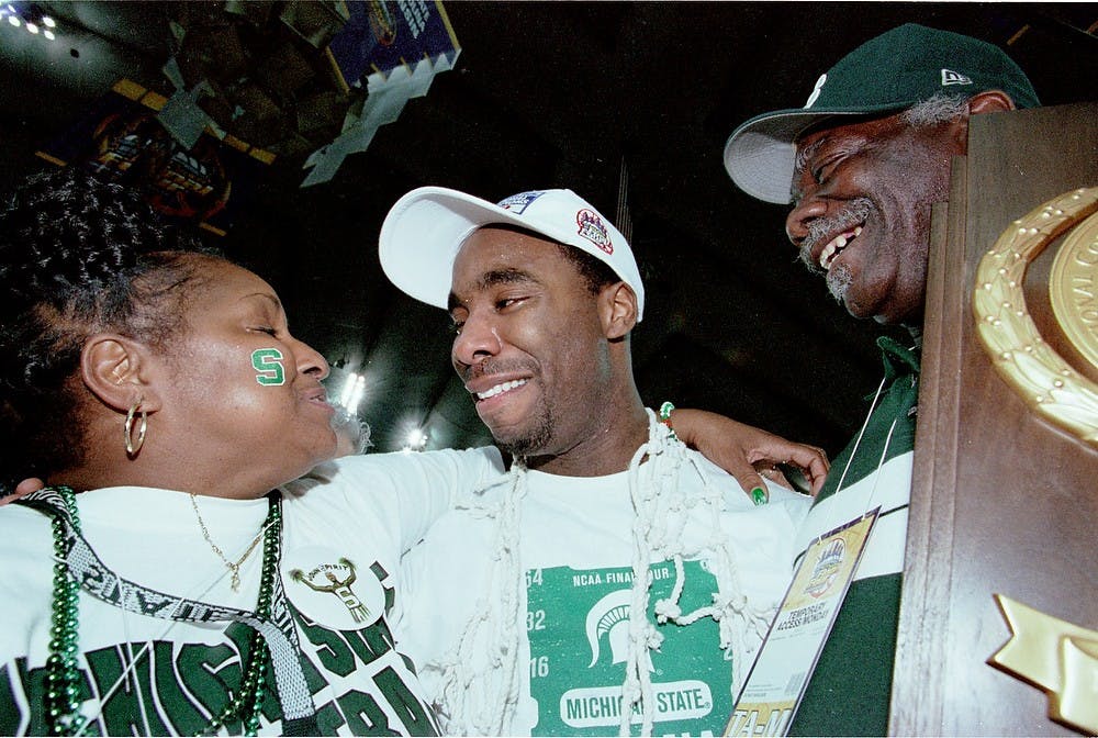 <p>Former MSU guard Mateen Cleaves celebrates with his family after winning the National Championship trophy April 3, 2000, in Indianapolis, Indiana at the RCA Dome. Photo Courtesy of MSU Athletics</p>