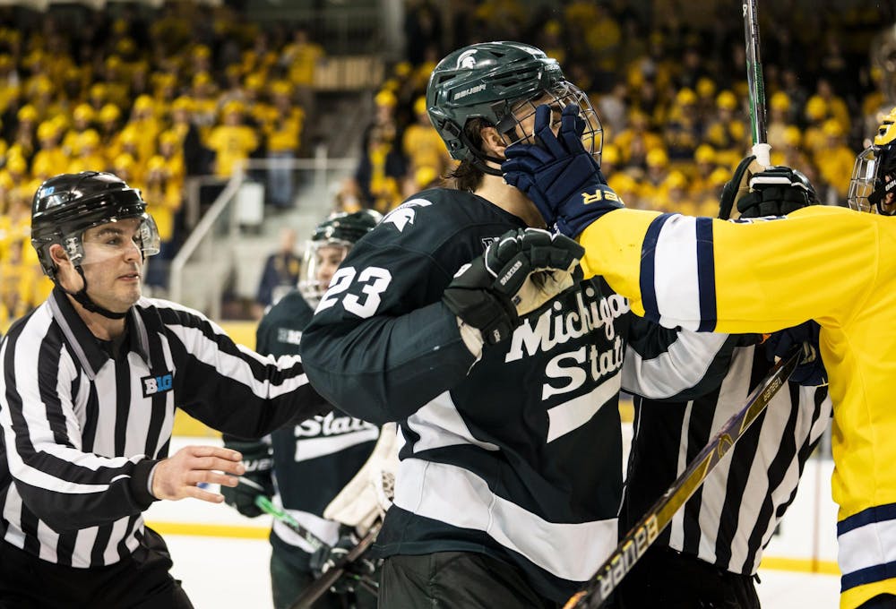 <p>The referees rush to break up fights between the Michigan State and University of Michigan men;s hockey players at the Yost Ice Arena in Ann Arbor, Mich. on Dec. 6, 2025.</p>