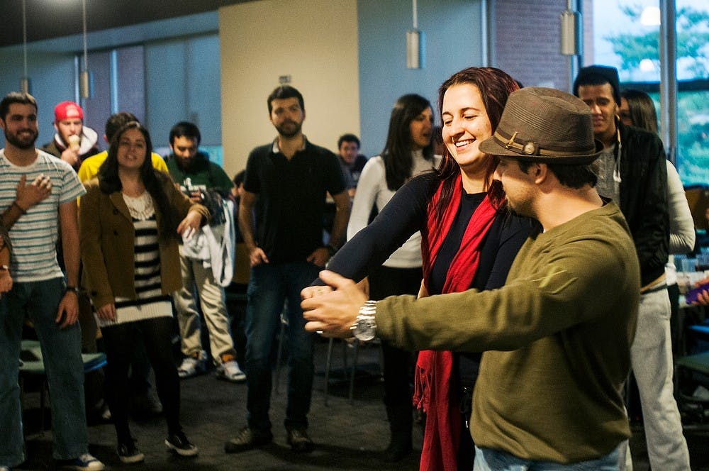 	<p>Foreign exchange students Michelle Parreira and Sherfis Ruwer dance during a Brazilian dinner, Oct. 23, 2013, at Holden Dining Hall. The event featured food, music, and dancing native to the Brazilian culture. Danyelle Morrow/The State News</p>