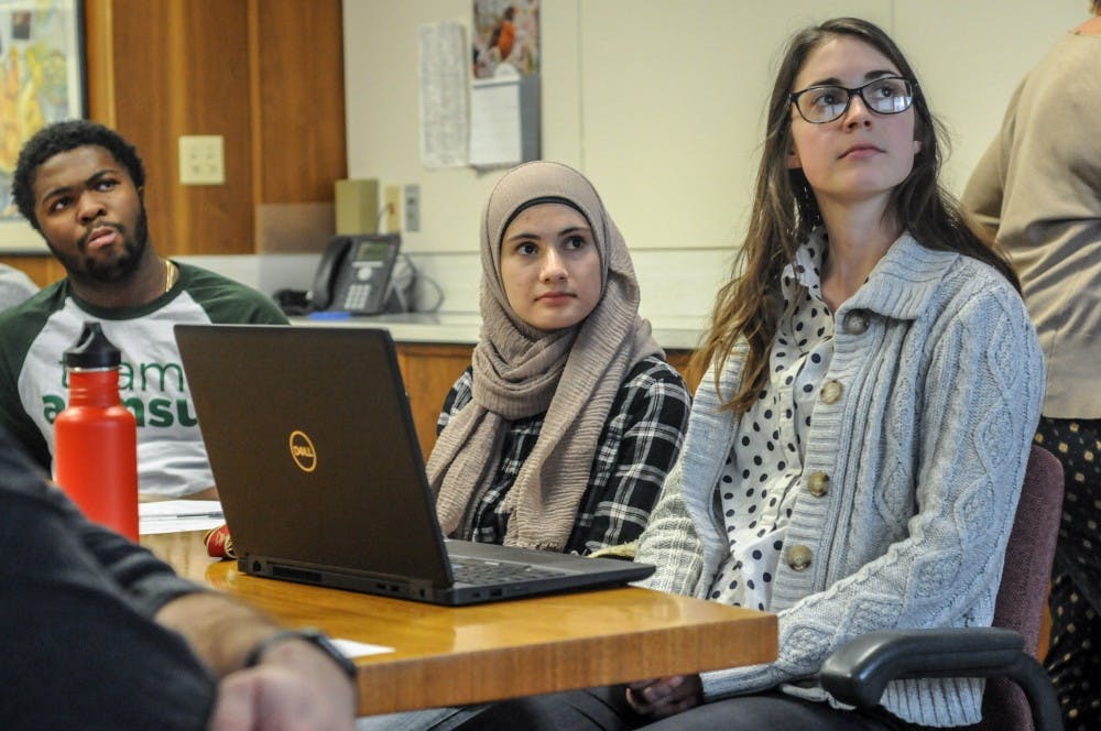 Members of the University Student Commission listen to a presentation at East Lansing City Hall on April 2, 2019.