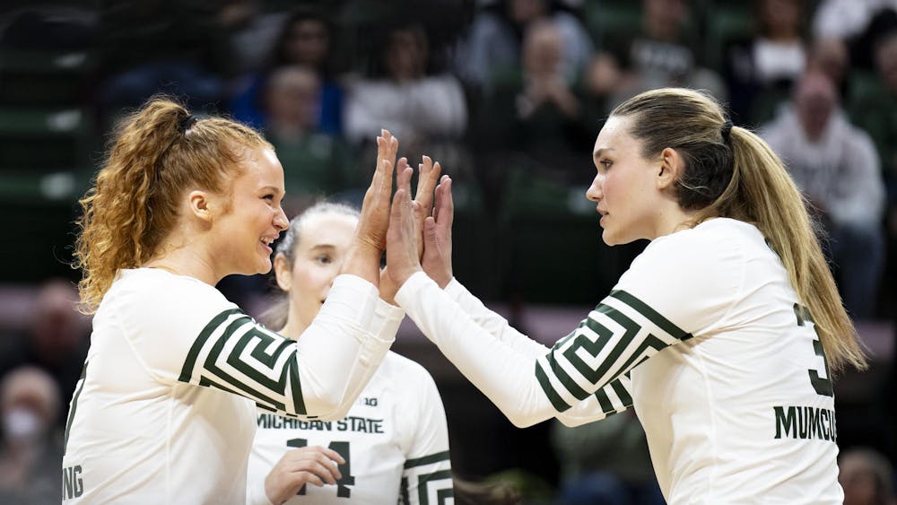 <p>MSU freshman outside hitter Bianca Mumcular (3) and redshirt freshman setter Malayah Long (7) high-five after a point during the match against USC at the Breslin Center on Wednesday, Nov. 26, 2025.</p>