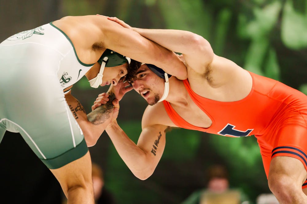 <p>Junior Chase Saldate tied up with his opponent during a meet against the University of Illinois, held at Jenison Fieldhouse on Feb. 5, 2023. The Spartans fell to the Illini 17-16.</p>