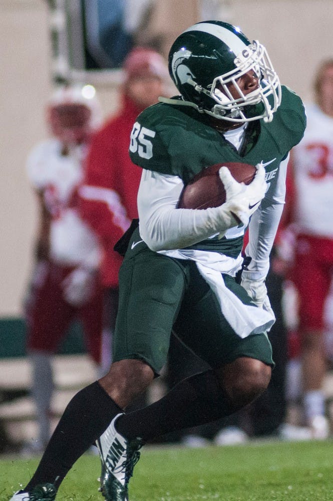 <p>Junior wide receiver Macgarrett Kings Jr. runs the ball down the field Oct. 4, 2014, during the game against Nebraska at Spartan Stadium. The Spartans defeated the Cornhuskers, 27-22. Erin Hampton/The State News</p>
