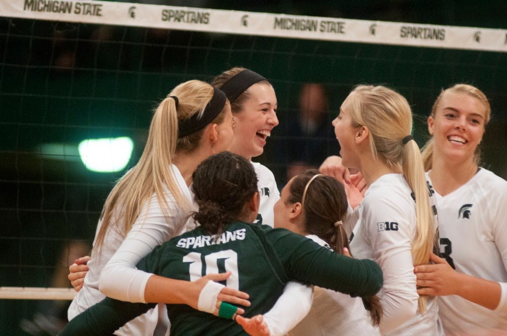 <p>Sophomore middle blocker Alyssa Garvelink celebrates getting a point with her team at the volleyball game against Michigan on Sept. 30, 2015 at Jenison Field House. The Spartans defeated the Wolverines, 3-0. </p>