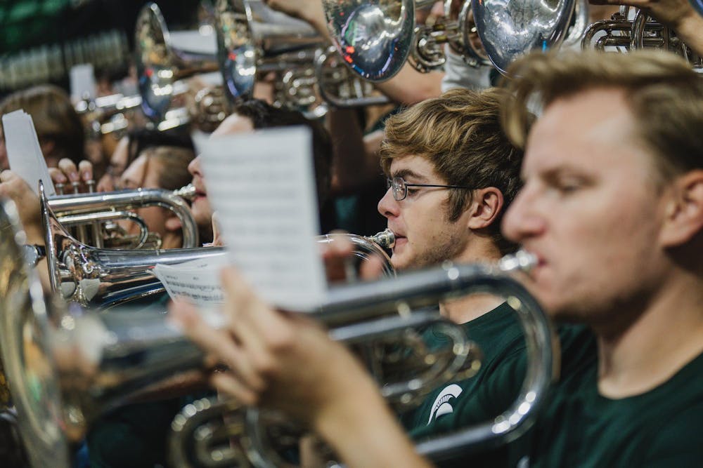 <p>MSU band members play their instruments in the Breslin center before a men's basketball matchup against Bowling Green on Nov. 16, 2024.</p>