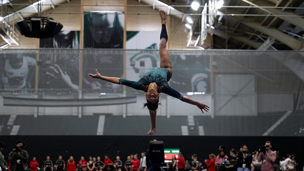 MaKayla Tucker, junior, performs an upside-down flip on the balance beam during the MSU tri-meet at Jenison Field House on Sunday, Feb. 15, 2026.